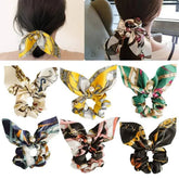 Silk patterned scrunchies with bow-like designs in various colors, featuring large intestine ring for fashion-forward style